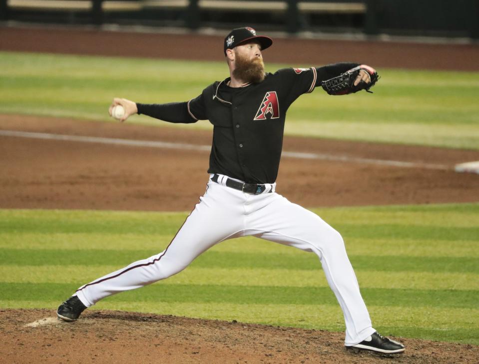 Arizona Diamondbacks relief pitcher Archie Bradley (25) delivers a pitch against the San Francisco Giants during the eighth inning at Chase Field Aug 30, 2020.