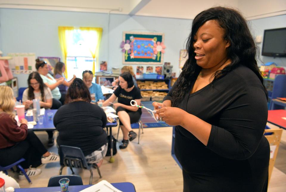 Early childhood mental health consultant Nashaylia Jenkins demonstrates and activity teachers can use the involve a child and make a calming tool to help children count their breaths during a workshop Monday, April 10, 2023, for teachers at Bright Beginnings Preschool in Sarasota. 