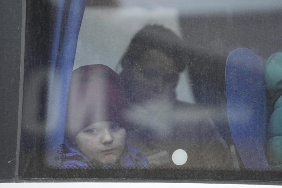 A child fleeing from Ukraine looks through the dusted window of a bus at the border crossing in Medyka, Poland, Friday, March 4, 2022. More than 1 million people have fled Ukraine following Russia's invasion in the swiftest refugee exodus in this century, the United Nations said Thursday. (AP Photo/Markus Schreiber)