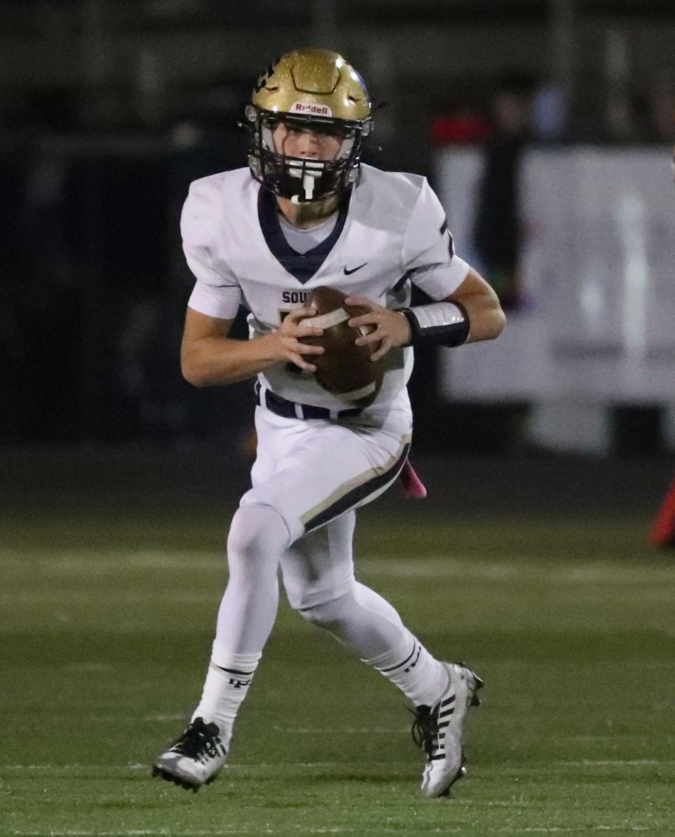 Grosse Pointe South's Anthony Bernard looks to pass against Grosse Pointe North during first-half action on Friday, Oct. 21, 2022.