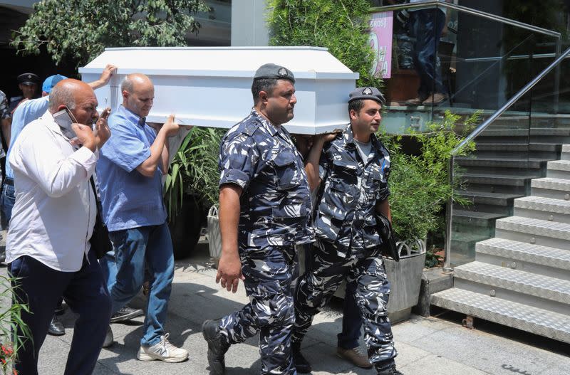 Lebanese internal security members carry a coffin containing the body of a man who committed suicide in Beirut