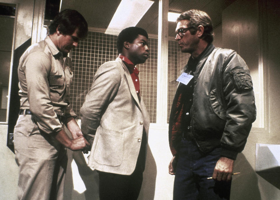 Actor Steve McQueen, right, shown with actor LeVar Burton, center, in a  Paramount film " The Hunter" in which he plays a modern bounty hunter. Man at left is unidentified. (AP Photo/Paramount)