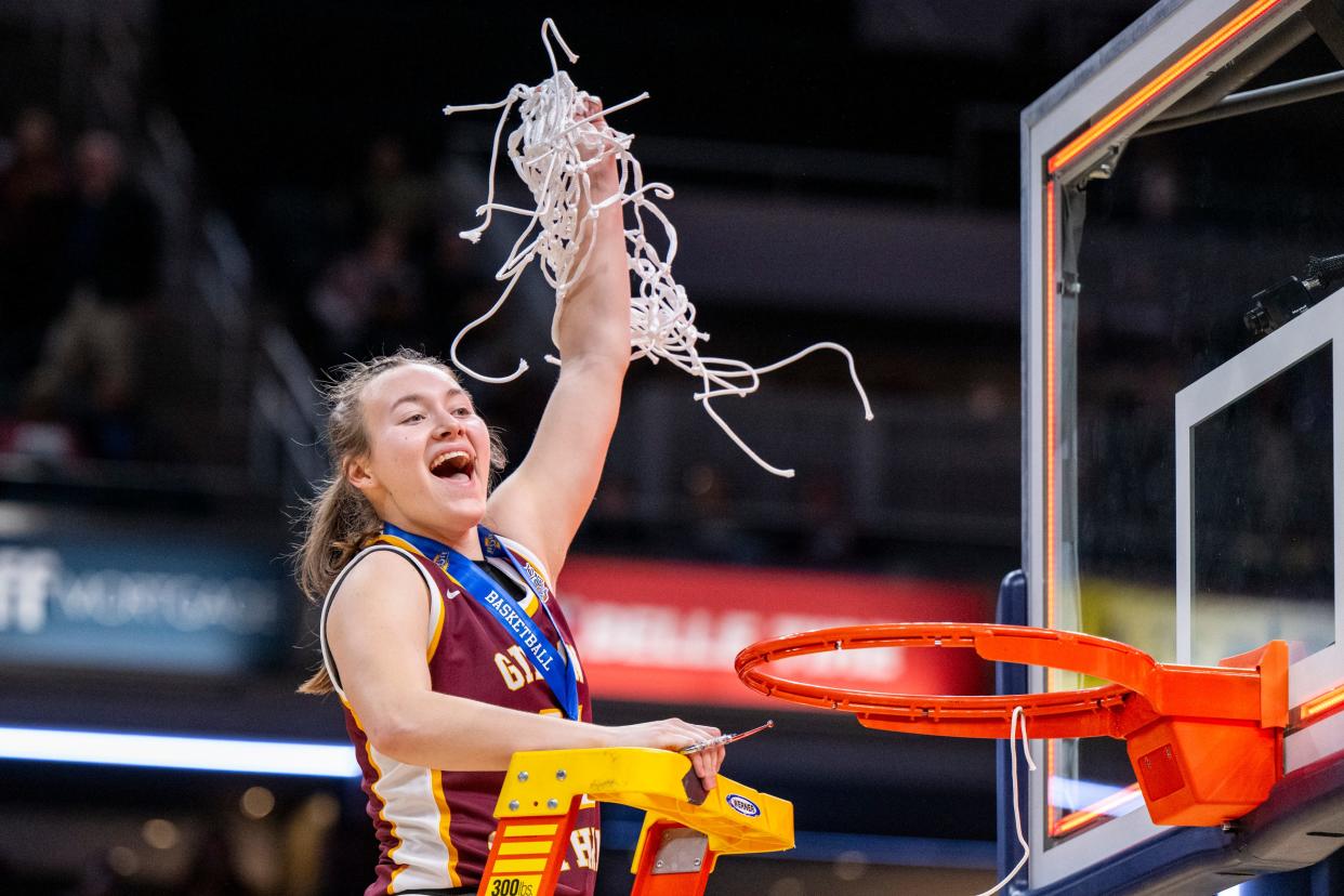 Gibson Southern High School senior Chloey Graham (41) celebrates after cutting down a net after defeating Norwell High School in an IHSAA class 3A girls’ basketball state finals game, Saturday, Feb. 24, 2024, at Gainbridge Fieldhouse, in Indianapolis. Gibson Southern won, 63-60.