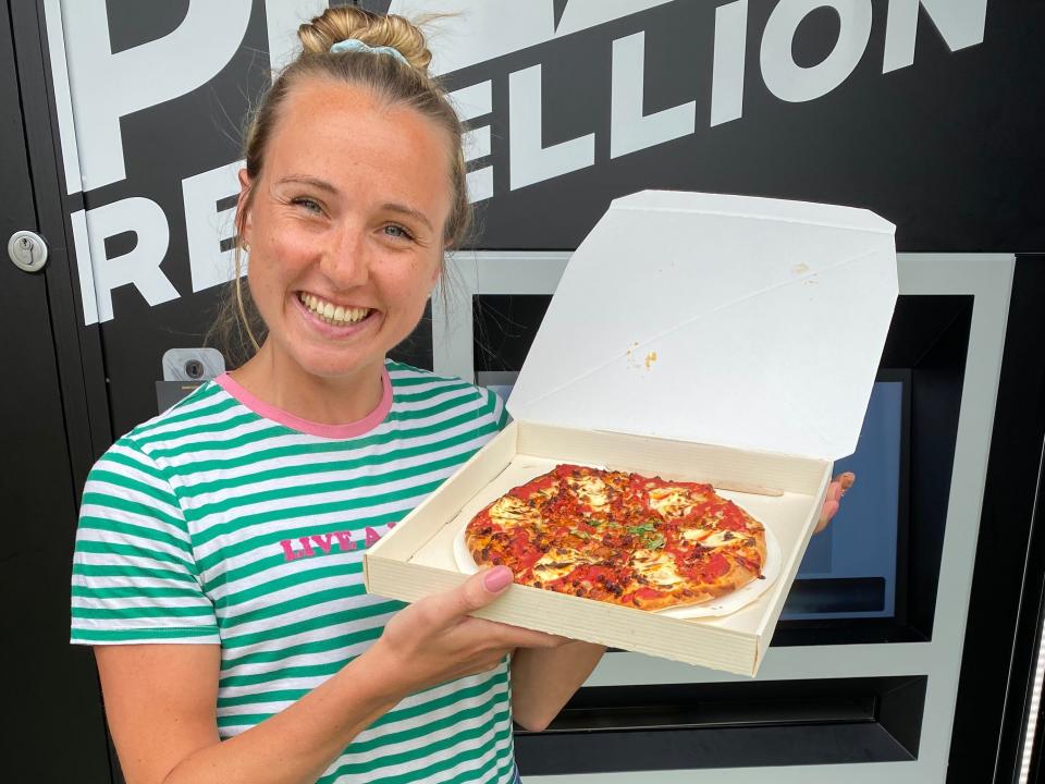 Rachel Hosie holding a pizza from Pizza Rebellion.