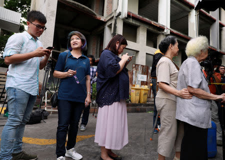 People wait to cast their vote in the general election at a polling station in Bangkok, Thailand, March 24, 2019. REUTERS/Soe Zeya Tun