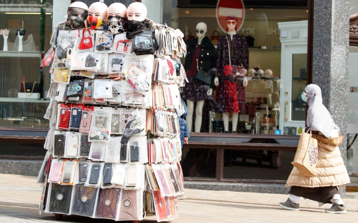 A shopper wears a face mask in Leeds city centre, West Yorkshire, where tougher lockdown measures were introduced after a rise in coronavirus infections.