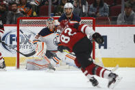 Edmonton Oilers goalie Mikko Koskinen (19) and defenseman Darnell Nurse (25) wait on a shot from Arizona Coyotes defenseman Jordan Oesterle (82) during the second period of an NHL hockey game Tuesday, Feb. 4, 2020, in Glendale, Ariz. The Coyotes won 3-0. (AP Photo/Ross D. Franklin)