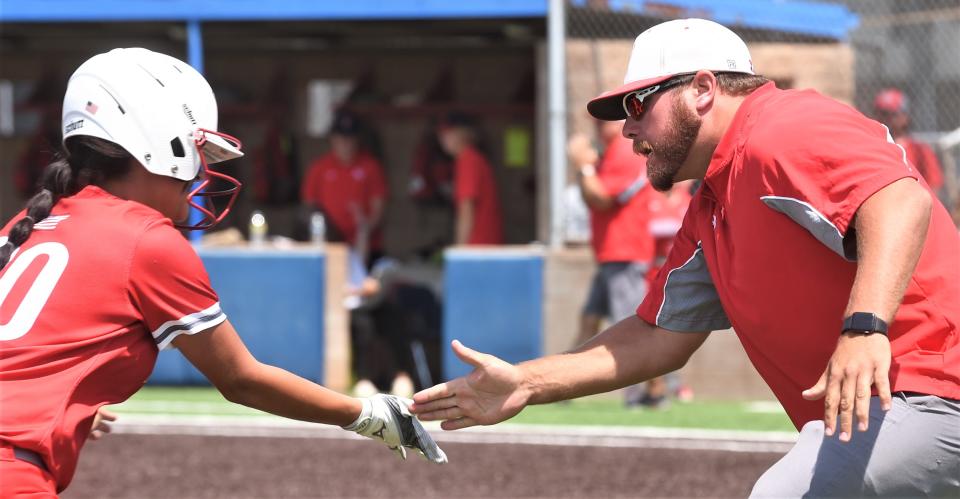 Hermleigh coach Sammy Winters, right, congratulates Hailey Minton after a grand slam against Eula.