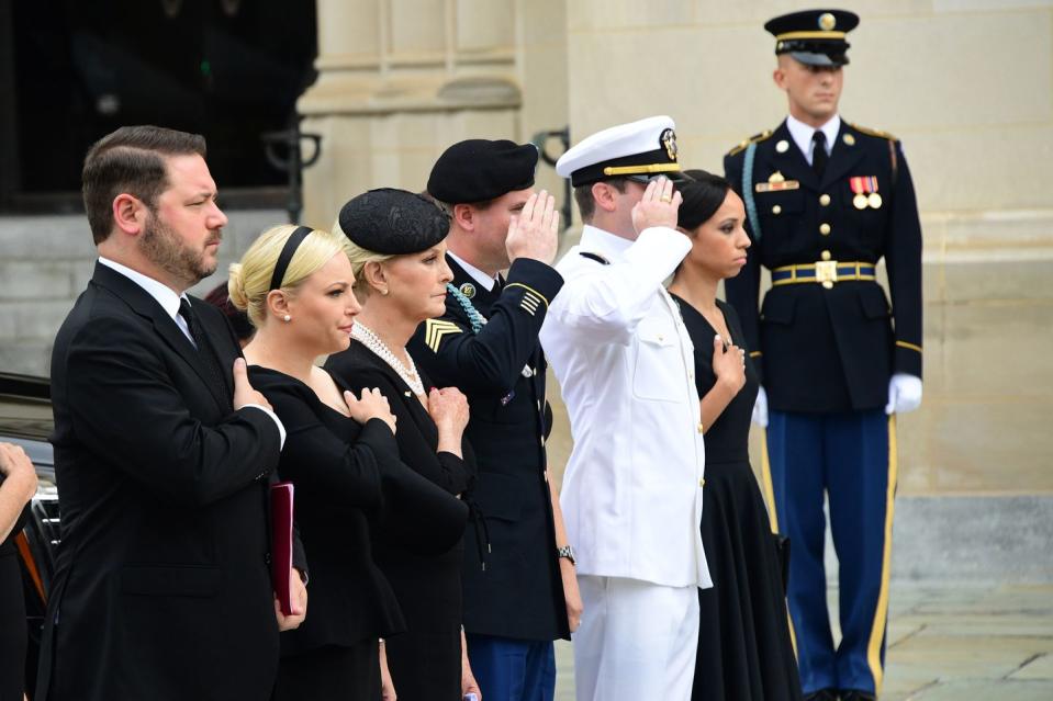 13) John McCain's family salutes his casket as it enter the Washington National Cathedral