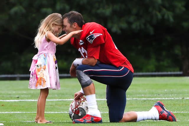 Eric Canha/CSM/Shutterstock Tom Brady and daughter Vivian Lake Brady on the sidelines of a football game.