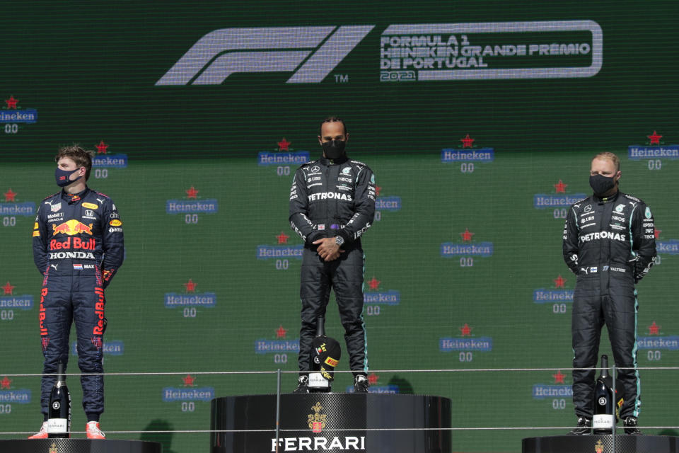 Second placed Red Bull driver Max Verstappen of the Netherlands, winner Mercedes driver Lewis Hamilton of Britain and third placed Mercedes driver Valtteri Bottas of Finland, from left, stand on the podium of the Portugal Formula One Grand Prix at the Algarve International Circuit near Portimao, Portugal, Sunday, May 2, 2021. (AP Photo/Manu Fernandez)