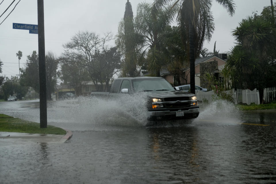 A pick up truck makes it way through flooded streets of Panorama City section of the San Fernando Valley in Los Angeles Saturday, Feb. 2, 2019. Flash flood warnings were issued for vast swaths of Southern California and forecasters said the system will bring several inches of rain at lower elevations and heavy snow in the mountains. (AP Photo/Richard Vogel)