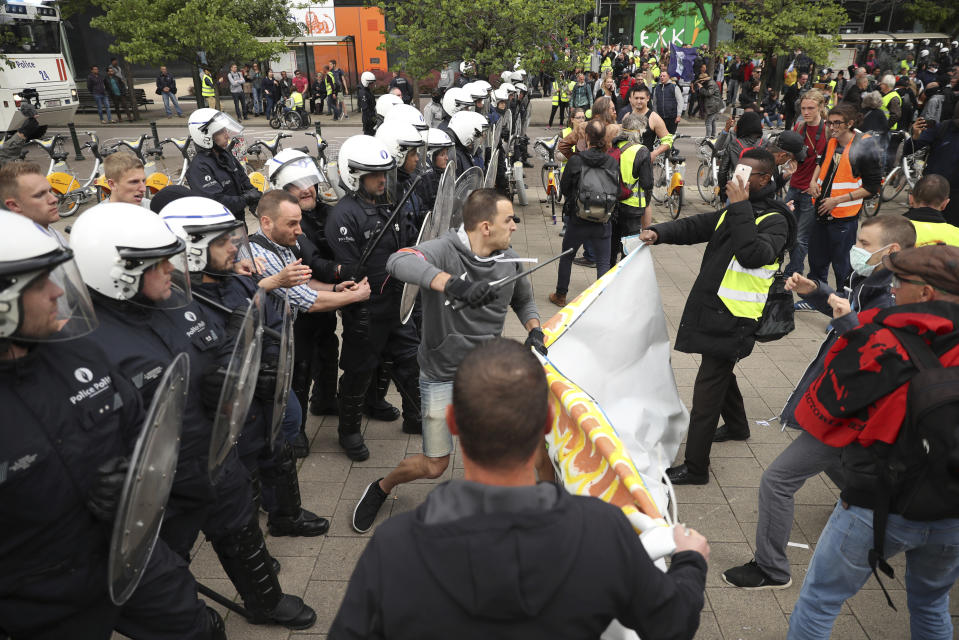 Police scuffle with yellow vest protestors and other groups during a demonstration in Brussels, Sunday, May 26, 2019. The demonstration took place as Belgium took to the polls to elect regional, national and European candidates. (AP Photo/Francisco Seco)