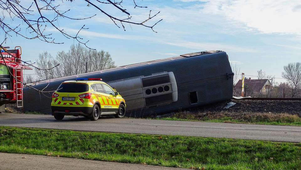 A derailed train lays in a ditch close to Mindszent, 140 kilometres (86 miles) southeast of Budapest on April 5, 2022. - Five people died in the train crash when a van drove onto the rails at a crossing, causing the train to derail, police said. All of the victims were passengers in the van which was carrying workers to work, police said in a statement. (Photo by FERENC DONKA / AFP) (Photo by FERENC DONKA/AFP via Getty Images)