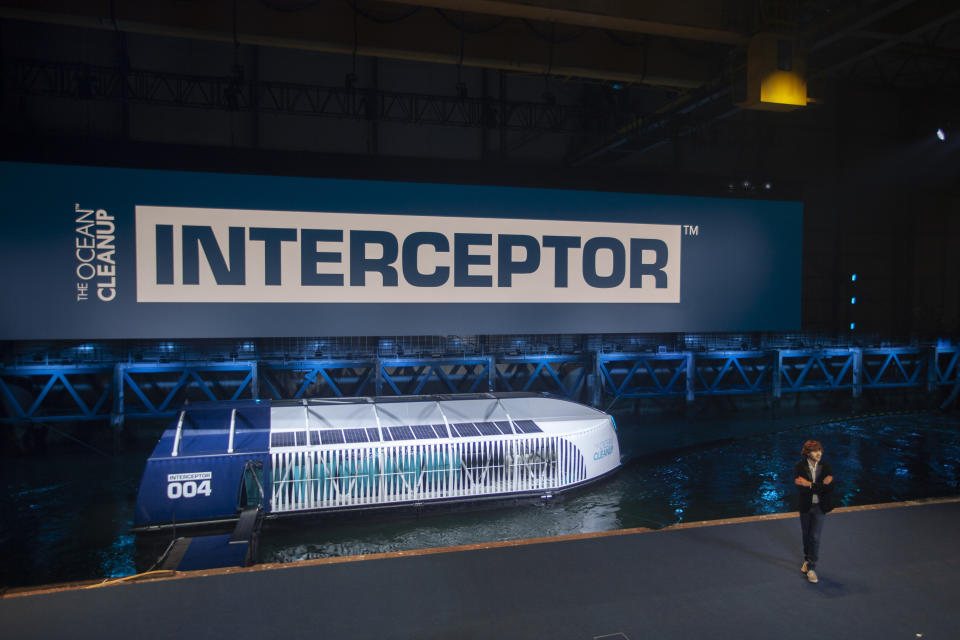 Young Dutch inventor Boyan Slat, right, unveils the Interceptor in Rotterdam, Netherlands, Saturday, Oct. 26, 2019. Slat is taking his effort to clean up floating plastic from the Pacific Ocean to rivers, using the Interceptor, a new floating device to catch garbage before it reaches the seas. (AP Photo/Peter Dejong)