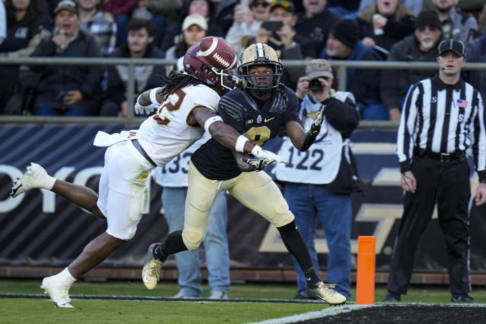 Purdue wide receiver TJ Sheffield, right, makes a catch for a touchdown as he's hit by Minnesota defensive back Darius Green (12) during the first half of an NCAA college football game in West Lafayette, Ind., Saturday, Nov. 11, 2023. (AP Photo/Michael Conroy)