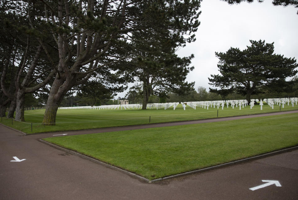 In this photo taken on Thursday, June 4, 2020, Arrows are painted on the ground to guide visitors to walk only one way, to prevent the spread of the coronavirus, at the Normandy American Cemetery in Colleville-sur-Mer, Normandy, France. In sharp contrast to the 75th anniversary of D-Day, this year's 76th will be one of the loneliest remembrances ever, as the coronavirus pandemic is keeping nearly everyone from traveling. (AP Photo/Virginia Mayo)