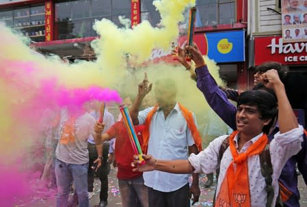 People celebrate after the government scrapped the special status of Kashmir, in Ahmedabad