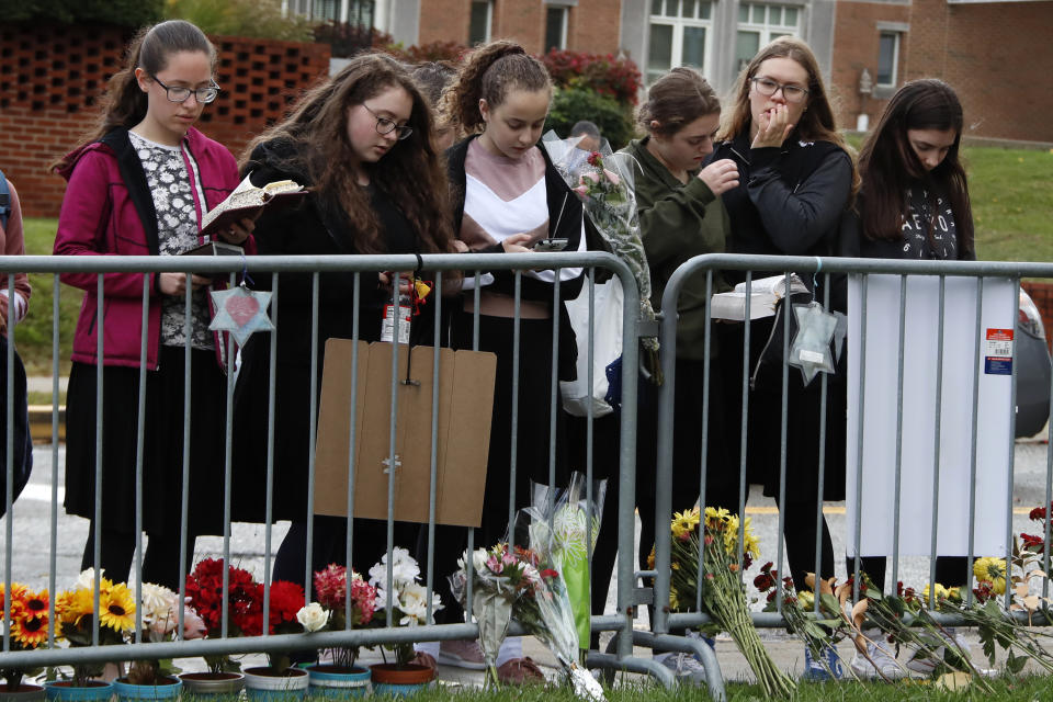 A group of students from a Pittsburgh Yeshiva school gather outside the Tree of Life synagogue in Pittsburgh on Sunday, Oct. 27, 2019, the first anniversary of the shooting at the synagogue, that killed 11 worshippers.(AP Photo/Gene J. Puskar)