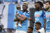 Napoli's Victor Osimhen, left, holds his daughter Hailey True, prior to the start of the Serie A soccer match between Napoli and Sampdoria at the Diego Maradona Stadium, in Naples, Sunday, June 4, 2023. (AP Photo/Andrew Medichini)