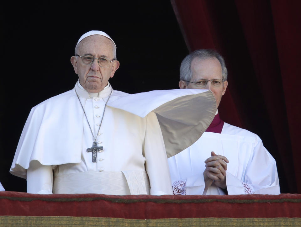 Pope Francis, flanked by Master of Ceremonies Bishop Guido Marini, looks at St. Peter's Square after the Urbi et Orbi (Latin for 'to the city and to the world' ) Christmas' day blessing from the main balcony of St. Peter's Basilica at the Vatican, Tuesday, Dec. 25, 2018. (AP Photo/Alessandra Tarantino)