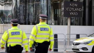 Britain's police officers patrol in front of Scotland Yard, central London, on February 14, 2022. (Photo by Tolga Akmen / AFP)