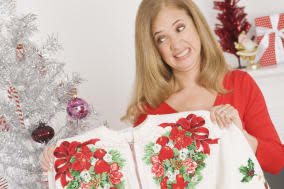 Cringing woman holding sweater she got for Christmas