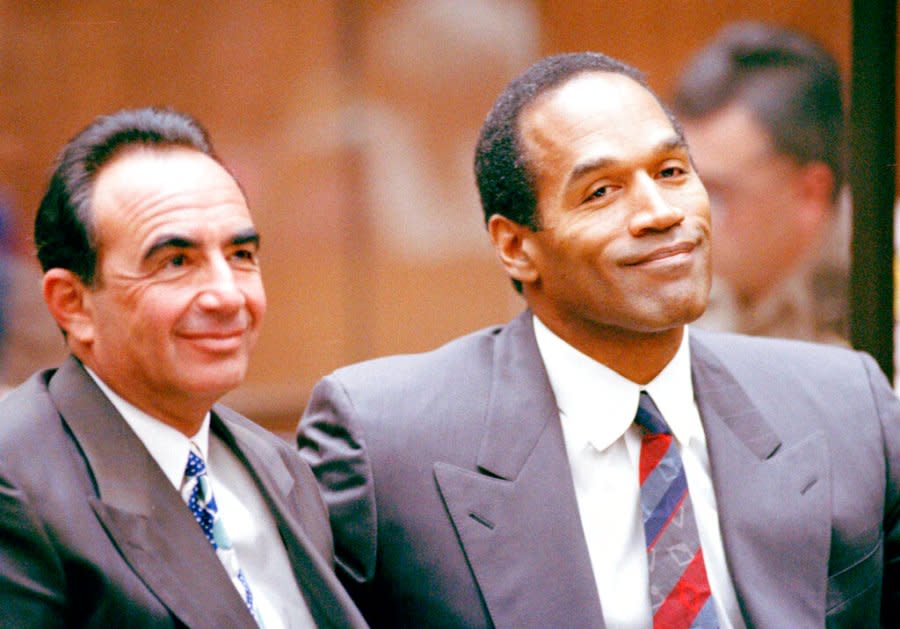 O.J. Simpson and his lawyer Robert Shapiro smile during hearing in Los Angeles court room, July 29, 1994. Judge Lance Ito set Sept. 20 for start of the trial. (AP Photo/Pool/Nick Ut)