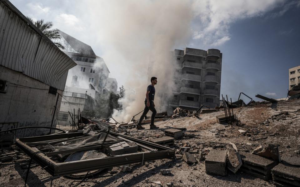 Palestinians inspect ruins after Israeli warplanes continued pounding attacks on Gaza Strip, - Getty