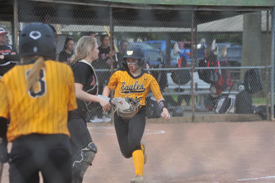 Colonel Crawford's Madison Cobb scores a run.