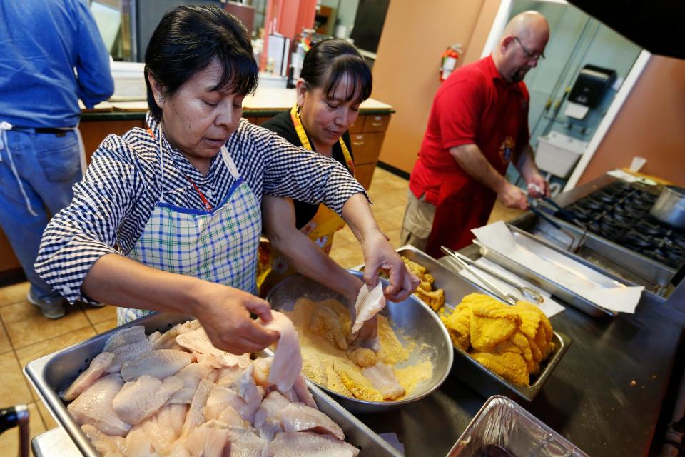 Irene Reyes (from left) and Lulu Mongaray coat fish fillets in the church's secret batter receipe as Al Snyder, a trustee with the Knights of Columbus council 644, fries it up Friday, March 20, 2015, at the church's weekly lenten fish fry at Bascilica of St. John in Des Moines. The church will hold its final fish fry of the Lenten season from 5 to 7 p.m. on Friday, March 27.