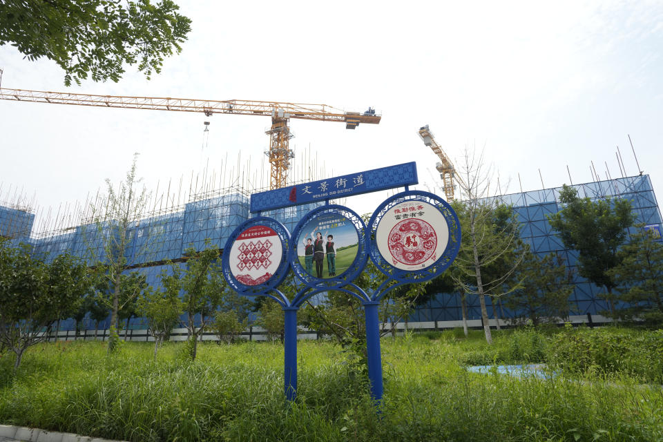 Propaganda promoting Chinese Socialist values are seen near the Country Garden One World City project under construction is seen on the outskirts of Beijing, Thursday, Aug. 17, 2023. China's government is trying to reassure jittery homebuyers after the major real estate developer missed a payment on its multibillion-dollar debt, reviving fears about the industry's shaky finances and their impact on the struggling Chinese economy. (AP Photo/Ng Han Guan)