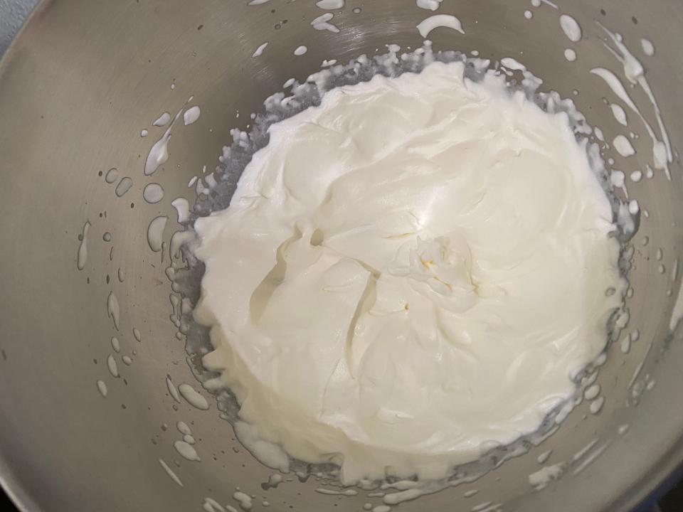 whipped cream in a metal mixing bowl