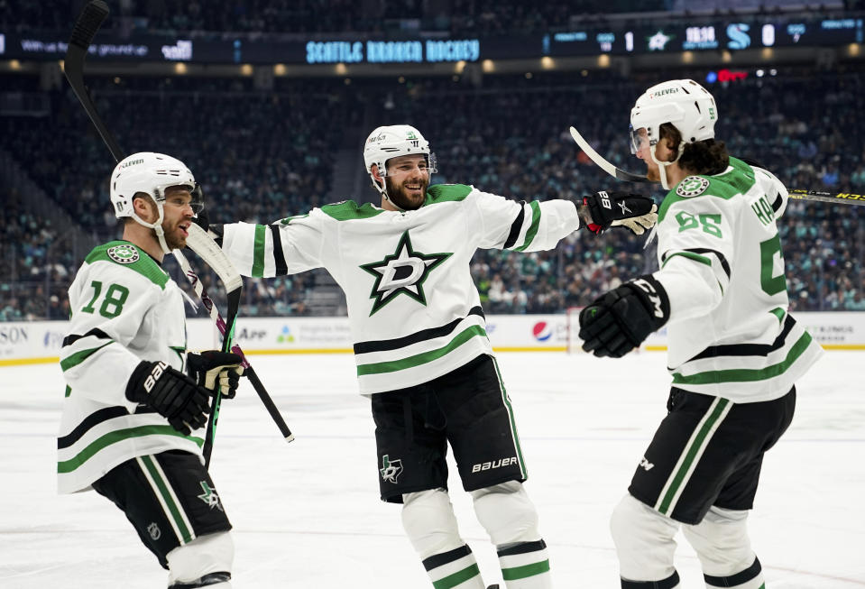 Dallas Stars center Max Domi (18) and center Tyler Seguin (91) greet defenseman Thomas Harley (55) after Harley scored against the Seattle Kraken during the second period of Game 4 of an NHL hockey Stanley Cup second-round playoff series Tuesday, May 9, 2023, in Seattle. (AP Photo/Lindsey Wasson)