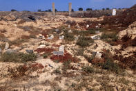 The "Cemetery of Unknown " where migrants who have died in the Mediterranean Sea while searching for a better life in Europe are buried, in theTunisian coastal town of Zarzis, Saturday June 12, 2021. A newly sanctified cemetery for Tunisia's migrant dead is filling quickly. Rachid Koraïchi bought the plot of land in the port city of Zarzis a few years ago and started designing what he hoped would be the final resting place for people who died on the move. Most of the headstones have dates but no names. (AP Photo/Mehdi El Arem)