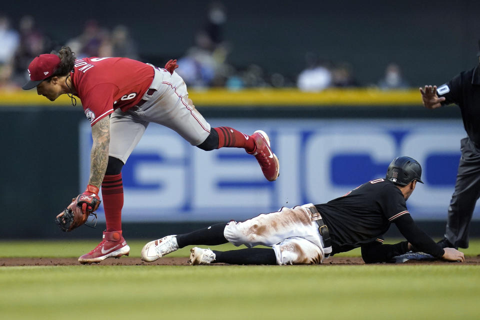 Cincinnati Reds second baseman Jonathan India (6) is unable to step on second base as Arizona Diamondbacks' Tim Locastro, right, slides safely into the bag on a single hit by Christian Walker during the fifth inning of a baseball game Saturday, April 10, 2021, in Phoenix. (AP Photo/Ross D. Franklin)