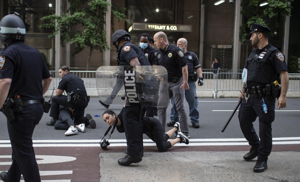 Police detain protesters in front of Trump Tower during a solidarity rally for George Floyd, Saturday, May 30, 2020, in New York. Demonstrators took to the streets of New York City to protest the death of Floyd, a black man who was killed in police custody in Minneapolis on May 25. (AP Photo/Wong Maye-E)