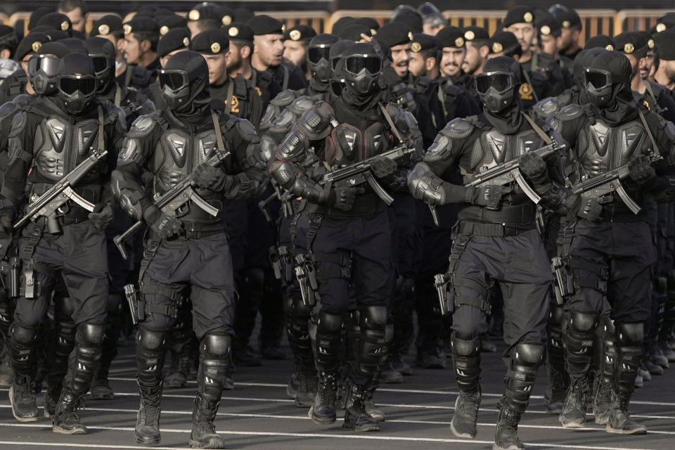 Members of the Saudi special forces, Special Force for Hajj and Umra (SFHU), warm up before a military parade in preparation for the annual Hajj pilgrimage in the Muslim holy city of Mecca, Saudi Arabia, Wednesday, June 21, 2023. (AP Photo/Amr Nabil)