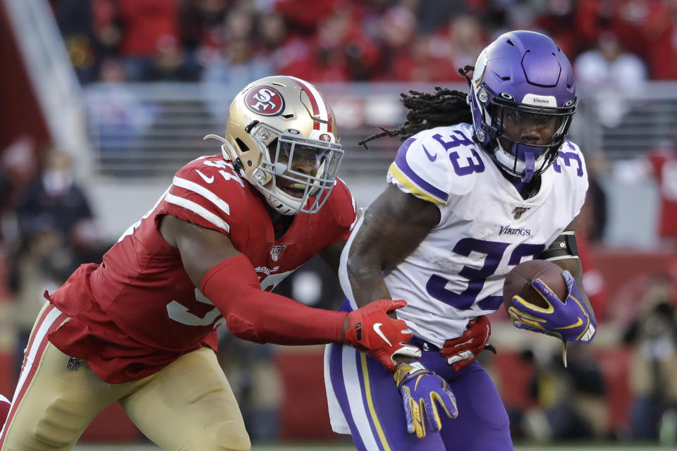 Minnesota Vikings running back Dalvin Cook (33) runs in front of San Francisco 49ers linebacker Dre Greenlaw during the second half of an NFL divisional playoff football game, Saturday, Jan. 11, 2020, in Santa Clara, Calif. (AP Photo/Marcio Jose Sanchez)