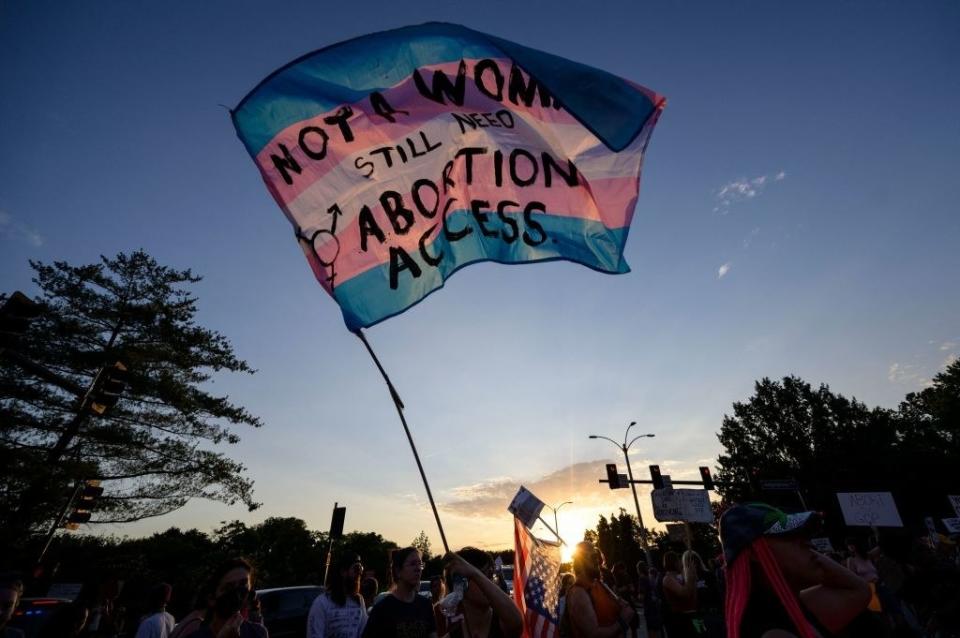 slogan written on a transgender flag