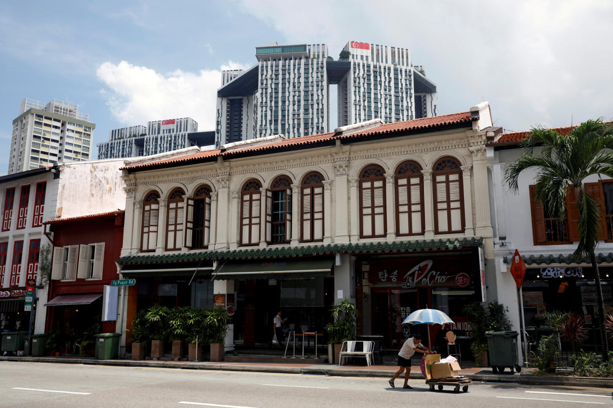 A cardboard collector pushing a cart past old shophouses in Singapore in 2017. (File photo: Reuters/Edgar Su)