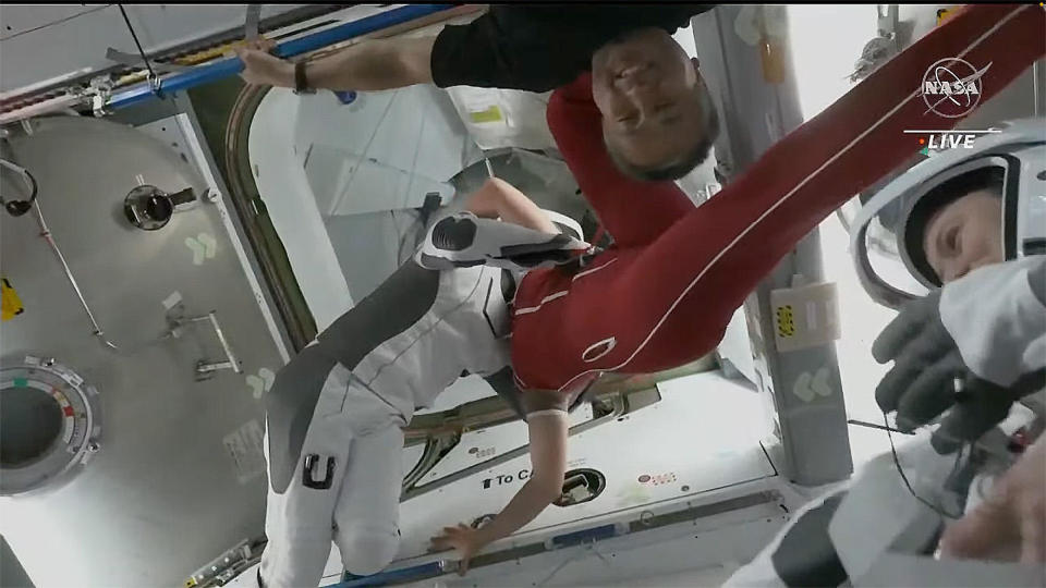 Cosmonaut Anna Kikina (in red) hugs NASA astronaut Jessica Watkins before the Crew 4 astronauts floated into their SpaceX capsule and closed the hatch for undocking. Japanese astronaut Koichi Wakata (top) looks on, along with European Space Agency astronaut Samantha Cristoforetti (bottom right)  / Credit: NASA TV