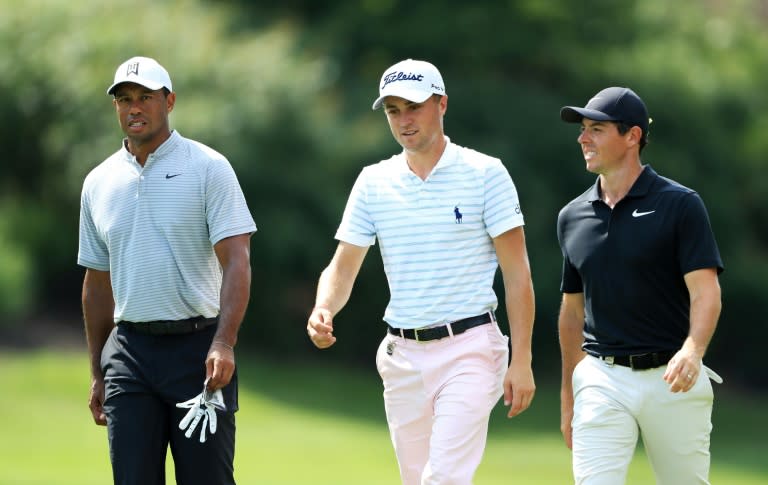 (L-R) Tiger Woods, Justin Thomas and Rory McIlroy walk to the eighth hole during the second round of the 2018 PGA Championship in St Louis