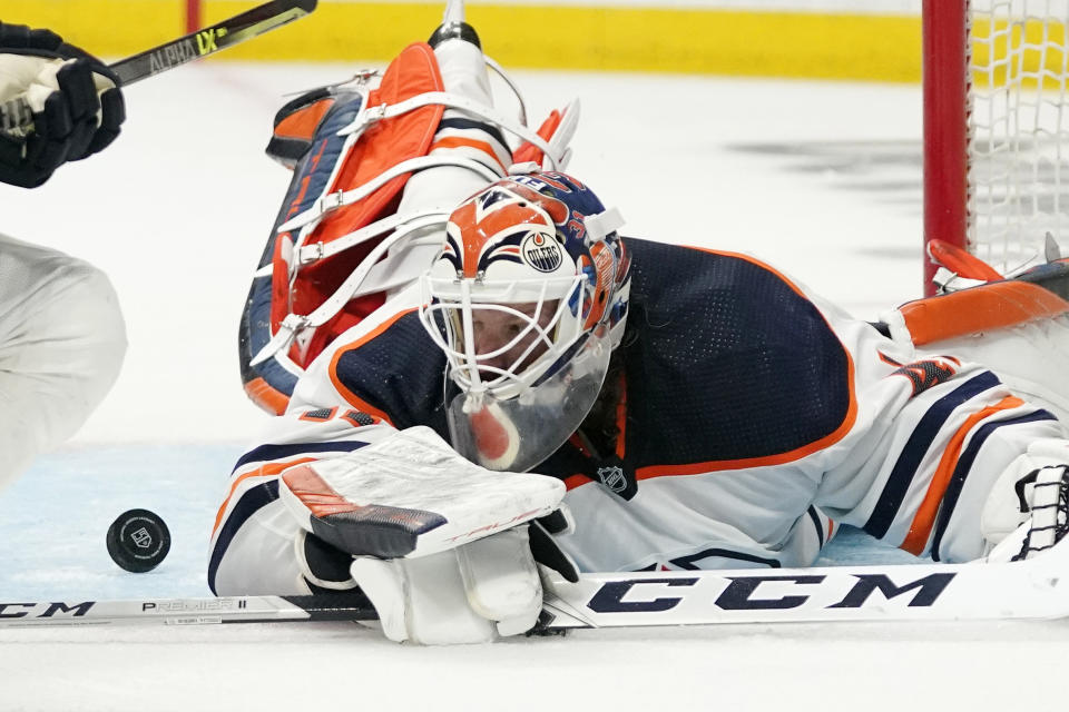 Edmonton Oilers goaltender Mike Smith stops a shot during the second period in Game 3 of an NHL hockey Stanley Cup first-round playoff series against the Los Angeles Kings Friday, May 6, 2022, in Los Angeles. (AP Photo/Mark J. Terrill)