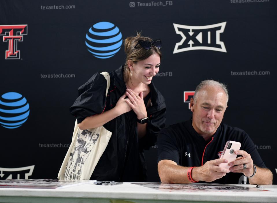 Texas Tech coach Joey McGuire visits with a fan during the Meet the Red Raiders event Saturday at the Sports Performance Center. Tech opens the season next Saturday at Wyoming.