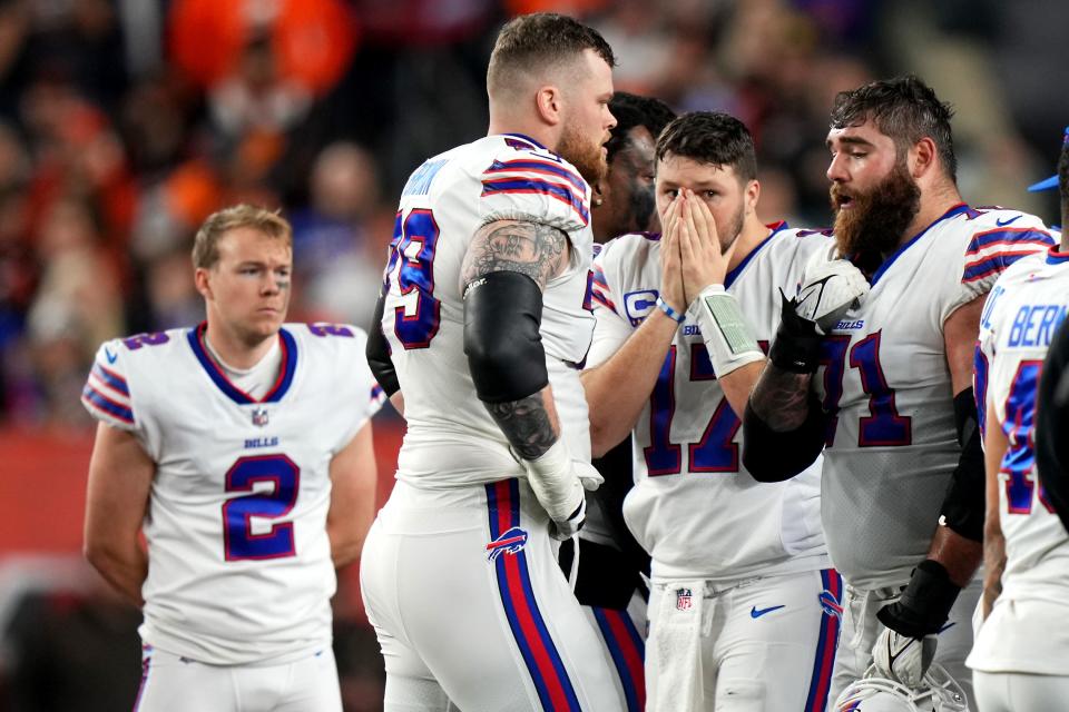 Quarterback Josh Allen (17) and the Buffalo Bills react as safety Damar Hamlin is tended to on the field.