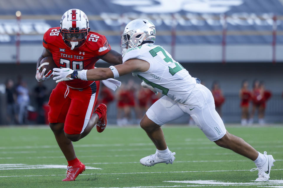 Texas Tech running back Tahj Brooks (28) breaks a tackle against an Oregon defender during the first half of an NCAA college football game, Saturday, Sept. 9, 2023, in Lubbock, Texas. (AP Photo/Chase Seabolt)