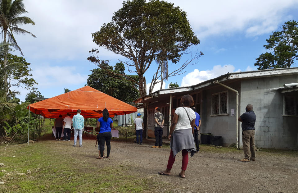 People queue for a COVID-19 vaccination in Suva, Fiji, Friday, June 25, 2021. A growing coronavirus outbreak in Fiji is stretching the health system and devastating the economy. It has even prompted the government to offer jobless people tools and cash to become farmers. (AP Photo/Aileen Torres-Bennett)