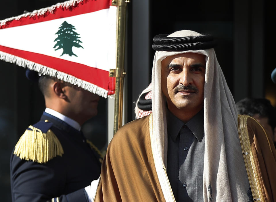 Qatar's Emir Sheikh Tamim bin Hamad Al Thani reviews the honor guard as he arrives at the Rafik Hariri international airport in Beirut, Lebanon, Sunday, Jan. 20, 2019. The ruler of the wealthy Gulf state of Qatar has arrived in Beirut to attend an Arab economic summit that has been marred by divisions over readmitting Syria to the Arab League. (AP Photo/Hussein Malla)