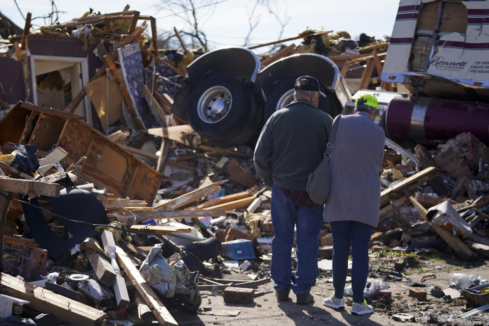 Harvey Cockrell, left, and his wife Mary Cockrell, look over their neighbors house, Lonnie and Melissa Pierce, who were killed when a semi truck landed on their house during a tornado that hit three days earlier, Monday, March 27, 2023, in Rolling Fork, Miss. The Cockrell's home was also damaged during the storm. (AP Photo/Julio Cortez)